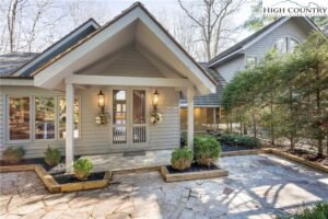 another gorgeous NC mountain house for sale with double glass doors leading into the entrance way