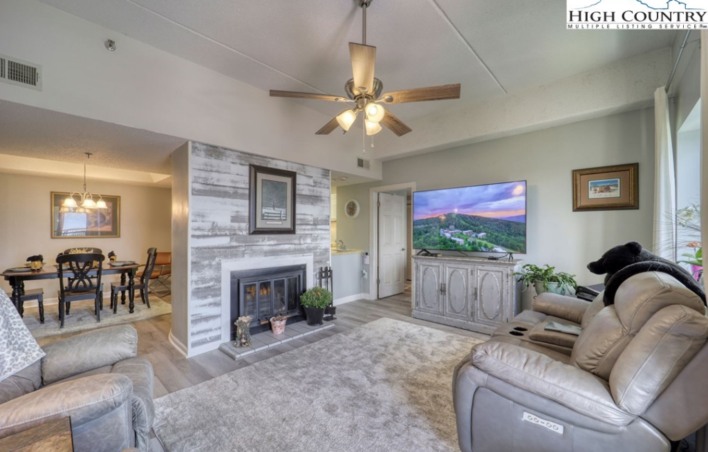 condos for sale in Blowing Rock, North Carolina, NC Mountain Properties, Madi Doble, living room with lights on, fireplace, arm chairs, Blowing Rock, NC realtor, Blowing Rock real estate for sale